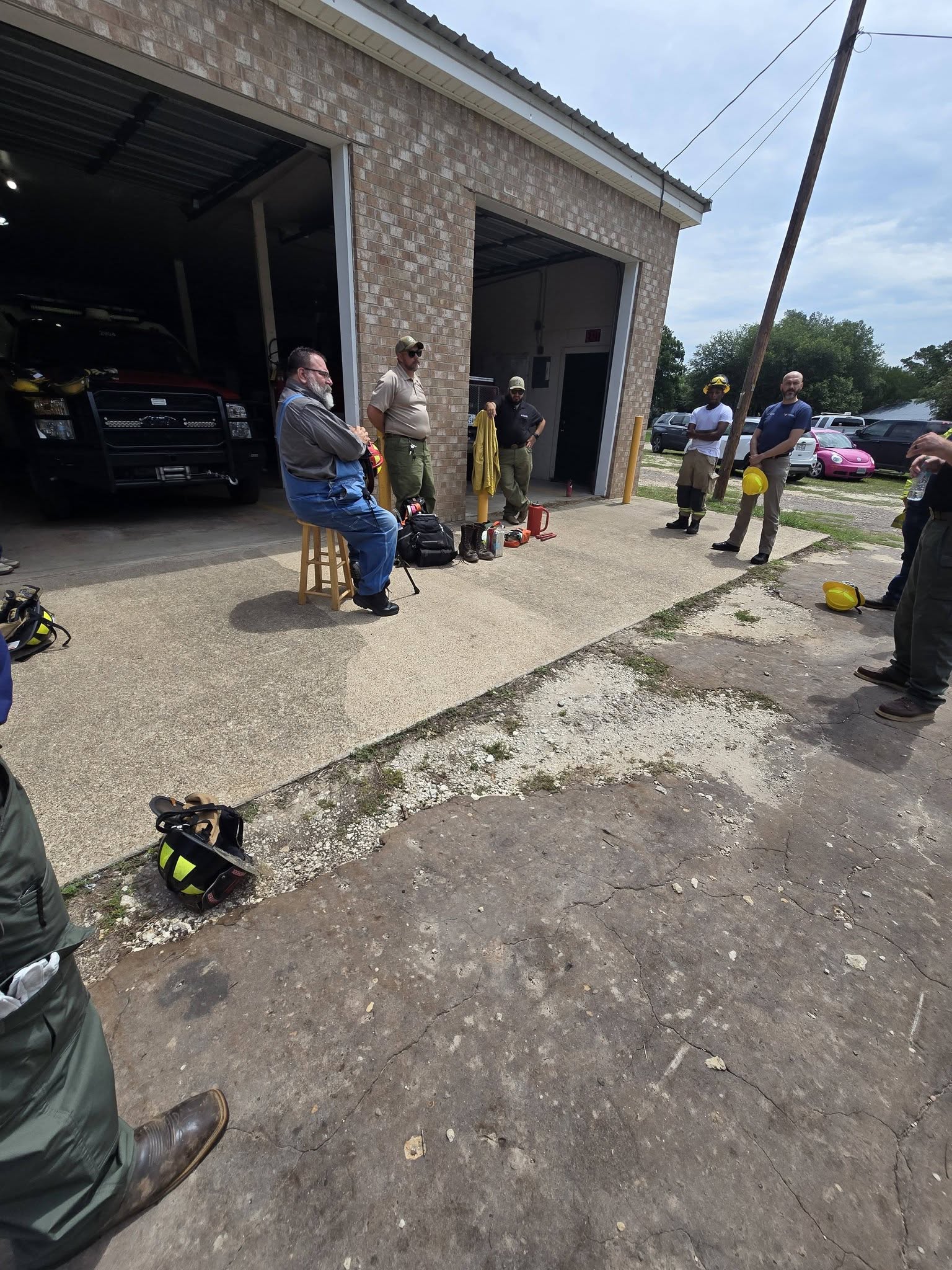 People and equipment gathered outside the brick Lake Mexia VFD station and its open apparatus bays.